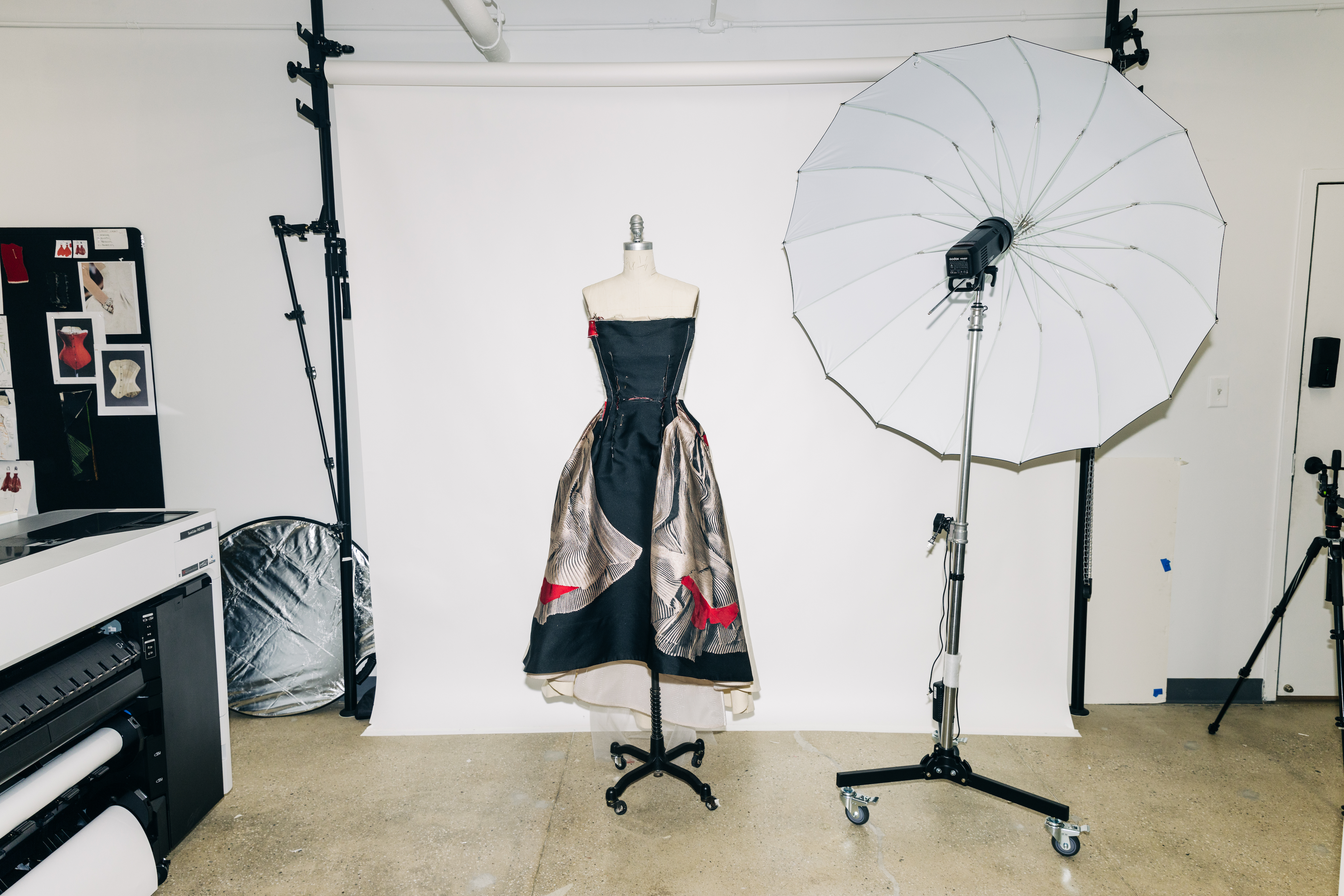 Dress on a mannequin with photography equipment in a studio setting